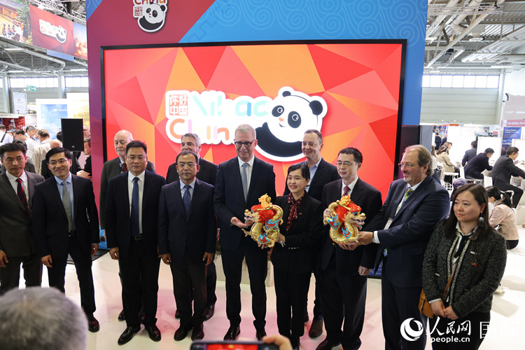 參加中國館開幕式的嘉賓們在“你好 中國” 展臺前合影留念。