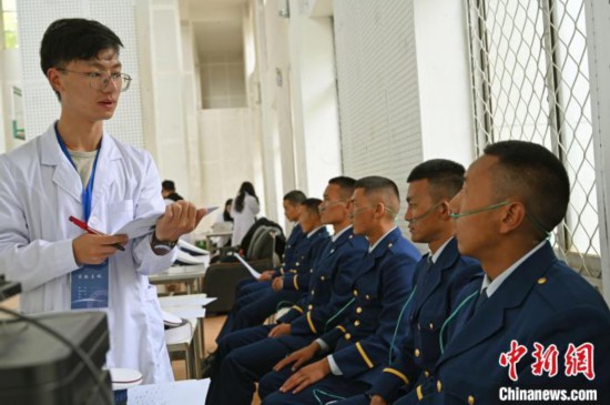 圖為研究團隊成員登記消防員信息。　趙朗 攝