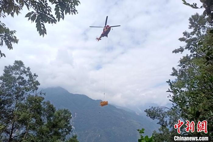 直升機起飛將搶修塔材運往海拔1950米的110千伏唐下線29號塔位?！⌒鞈c明 攝
