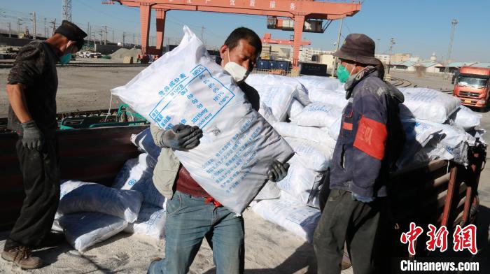 圖為裝卸人員將食鹽從汽車倒裝到火車上?！±钌?攝