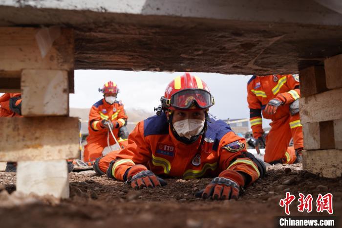 圖為地震實戰(zhàn)拉動現(xiàn)場，參演人員正在進行頂撐救援項目?！∮駱湎拦﹫D