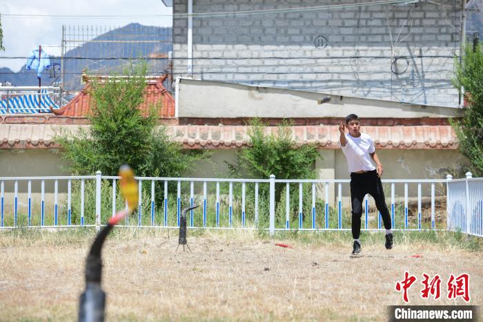 圖為西藏自治區(qū)拉薩市賽馬場(chǎng)內(nèi)市民在體驗(yàn)“打牛角”項(xiàng)目?！∝暩聛?lái)松 攝