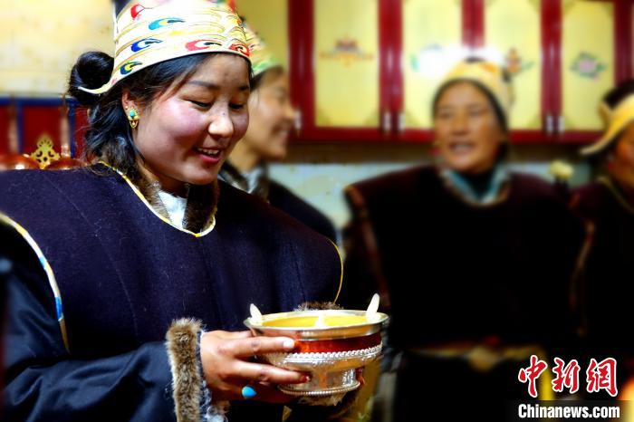 圖為藏族姑娘向客人敬酒?！∪轿木?攝